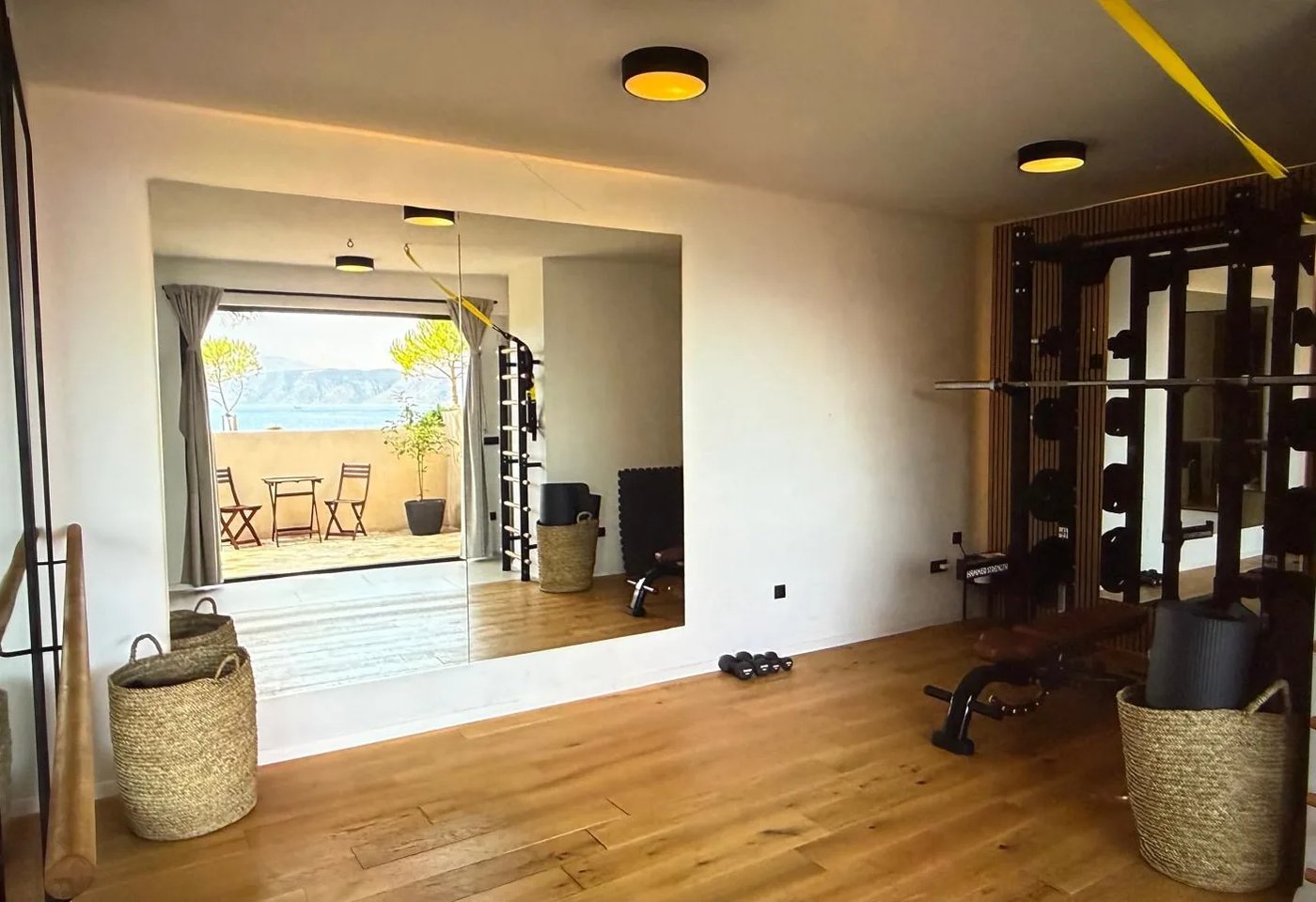Private gym with Hammer Strength machine and sea view terrace